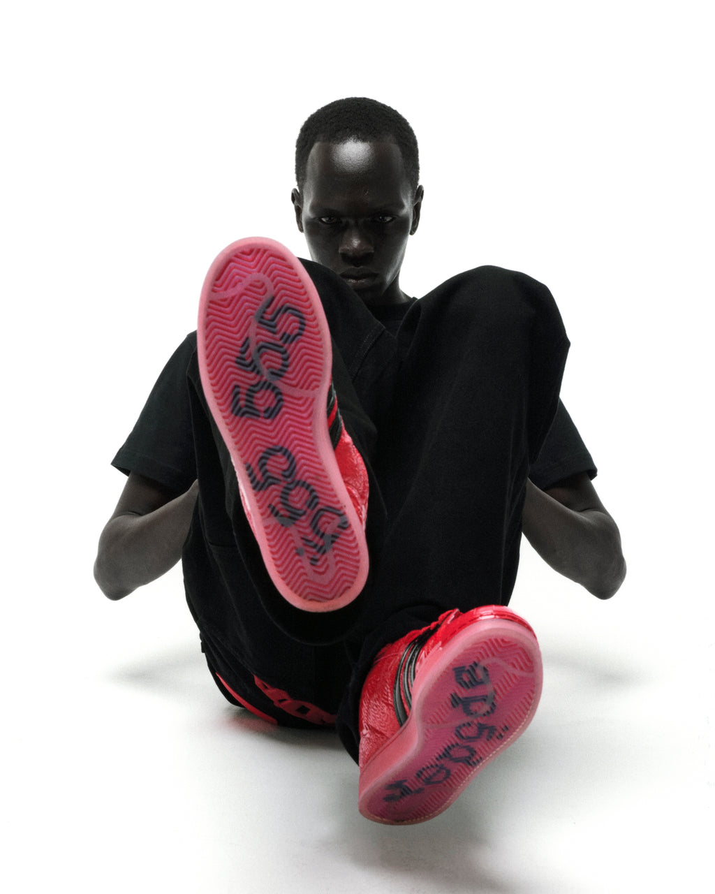 SP5DER x ADIDAS SUPERSTAR in black patent leather with glossy red translucent soles and graphic detailing.