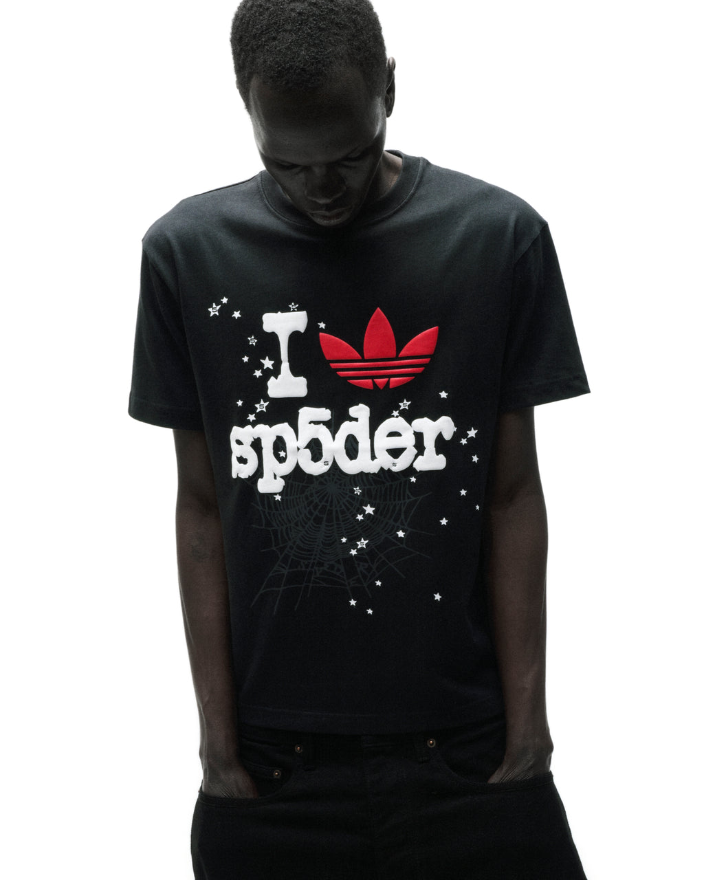 Black Adidas Souvenir Tee with red Trefoil and white "I sp5der" graphic, surrounded by stars and a spiderweb.