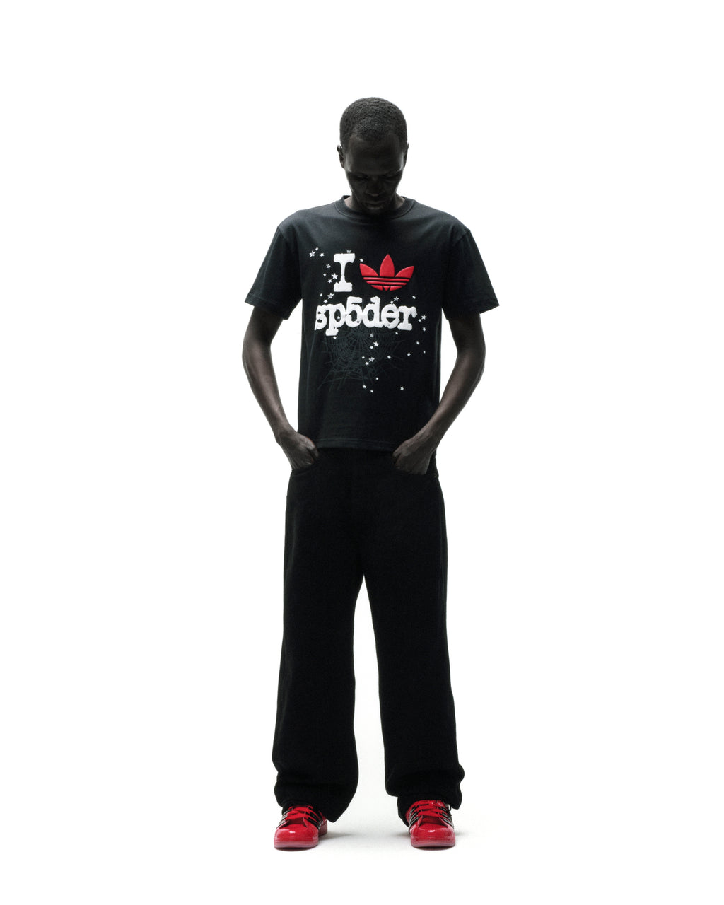 Black Adidas Souvenir Tee with red Trefoil and "I SP5DER" graphic, worn by a model.