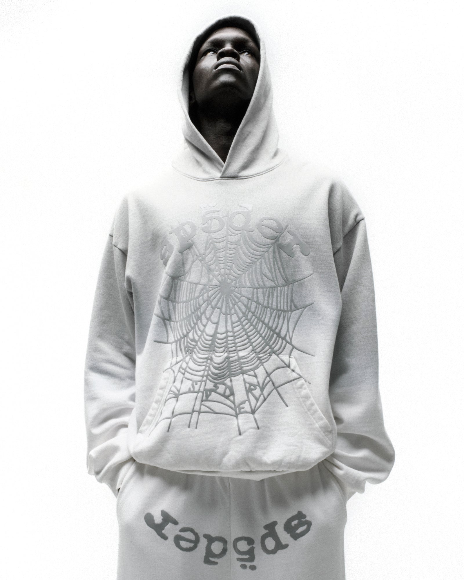 White OG WEB OMBRE HOODIE with a large spiderweb graphic and matching sweatpants.