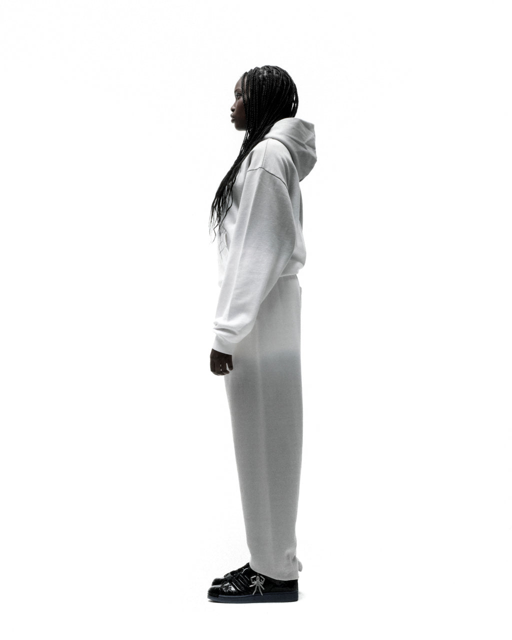 Model wearing a white OG WEB OMBRE HOODIE and matching sweatpants, showcasing the ombre design.