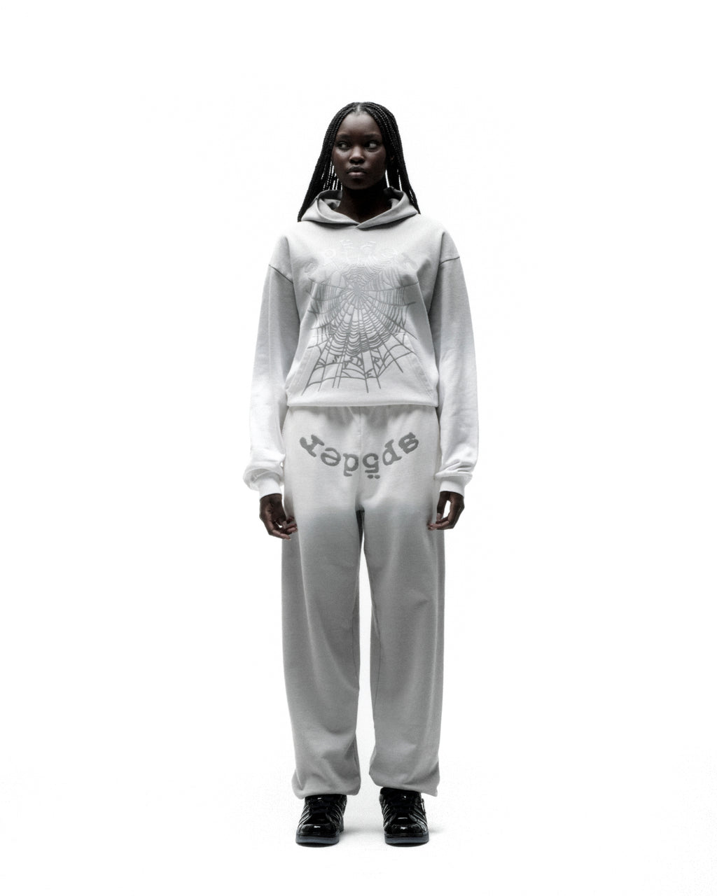 OG WEB OMBRE HOODIE: Light grey 13oz cotton fleece hoodie with silver spiderweb print, worn by a model.