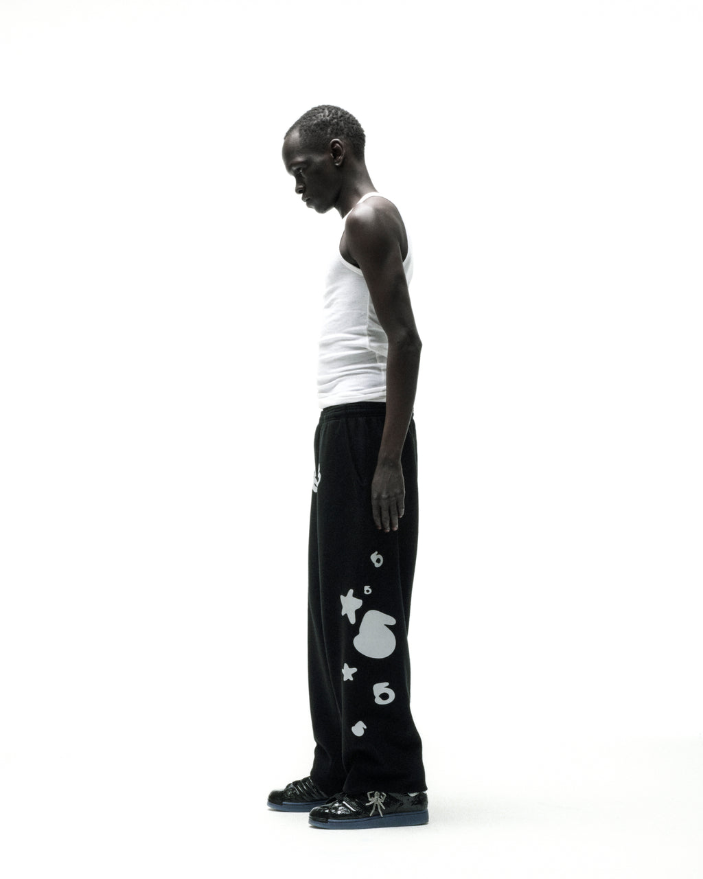 Black REFLECTIVE BELUGA SWEATPANT with white 'SP5DER' text, '5', and star designs.