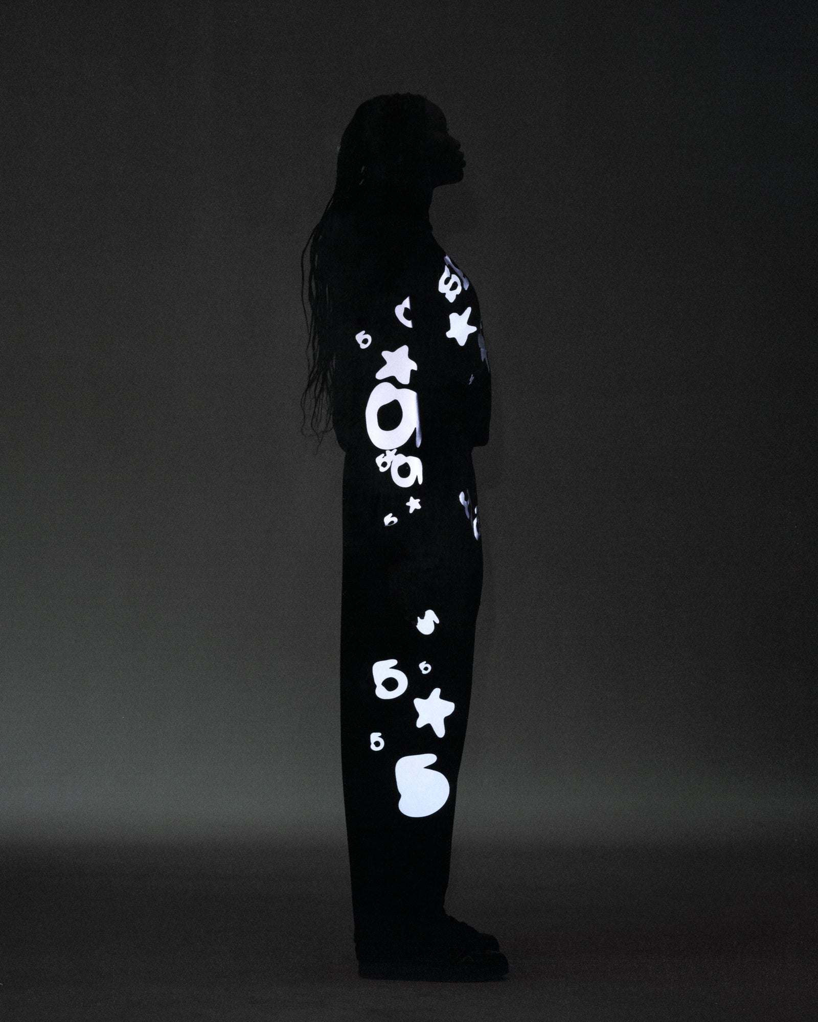 Black cotton fleece sweatpant with reflective 'SP5DER' text, '5', and star designs.