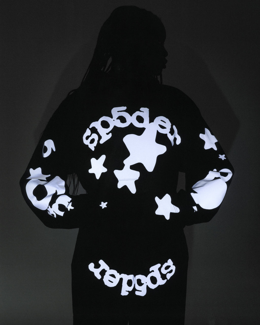 Black reflective Beluga hoodie with 'SP5DER' and star print on back, sleeves, and bottom.