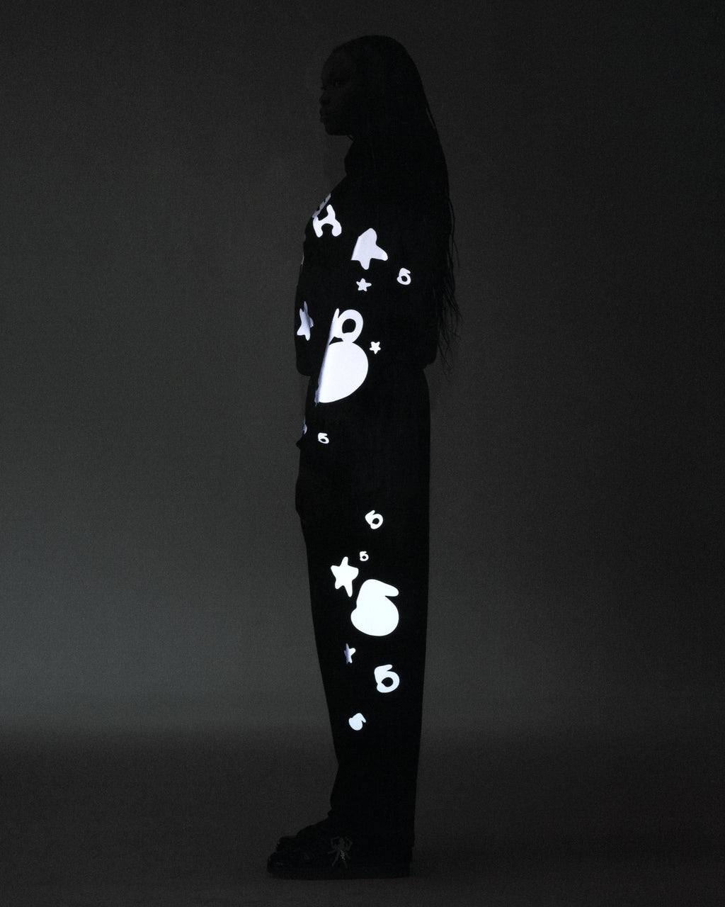Black reflective Beluga sweatpant with white 3M print, 'SP5DER' at crotch, '5' and star designs.