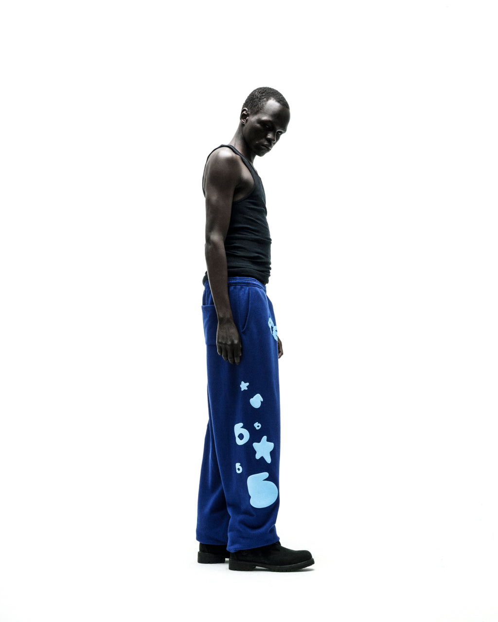 Model wearing blue BELUGA V2 SWEATPANT with light blue puff print stars and '5' graphics.