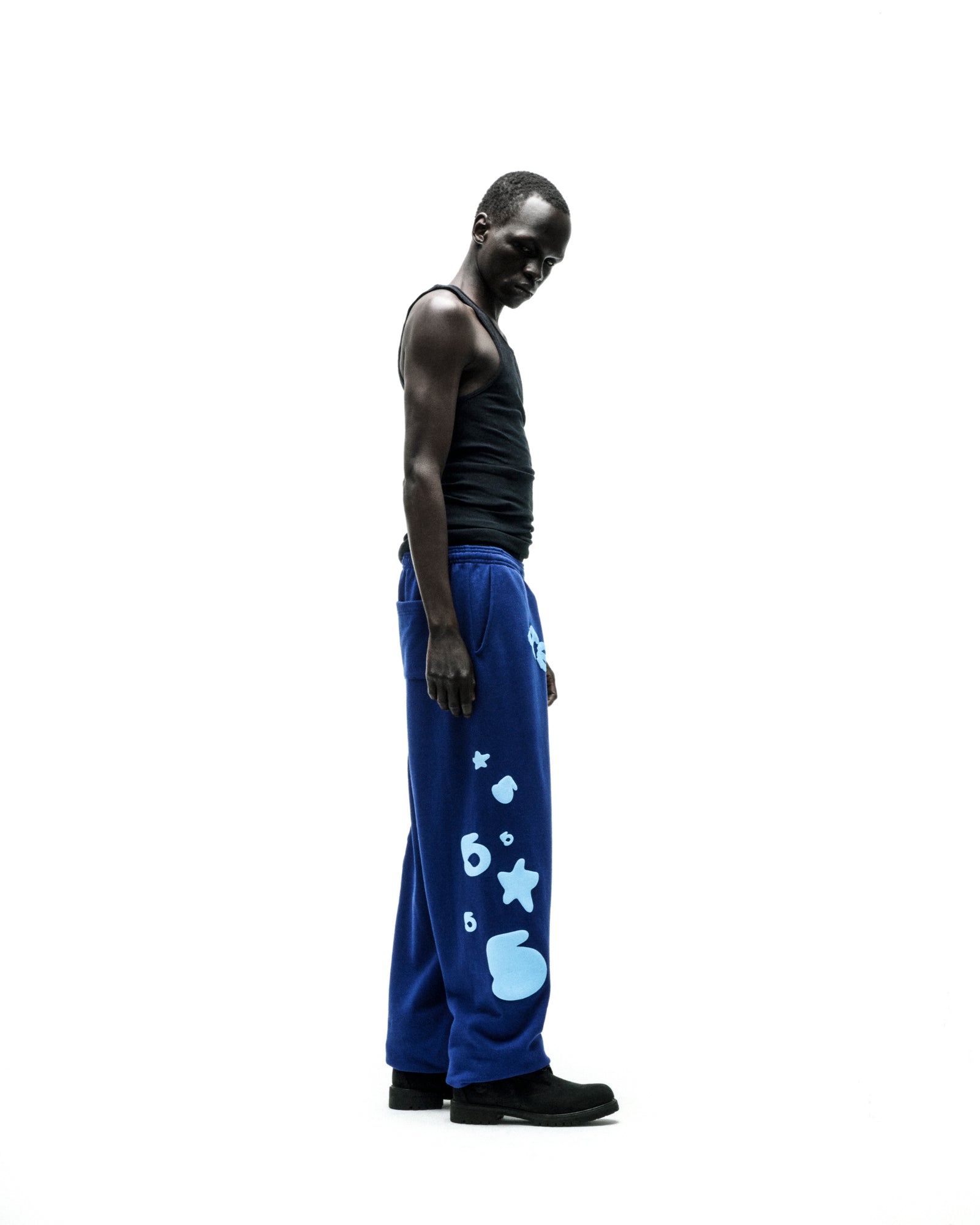 Model wearing blue BELUGA V2 SWEATPANT with light blue puff print stars and '5' graphics.