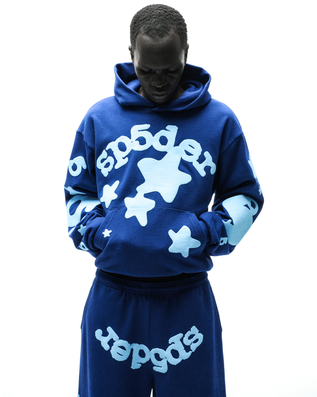 Beluga Hoodie: Blue 13oz cotton fleece with "SP5DER" and star puff/discharge print, kangaroo pocket.