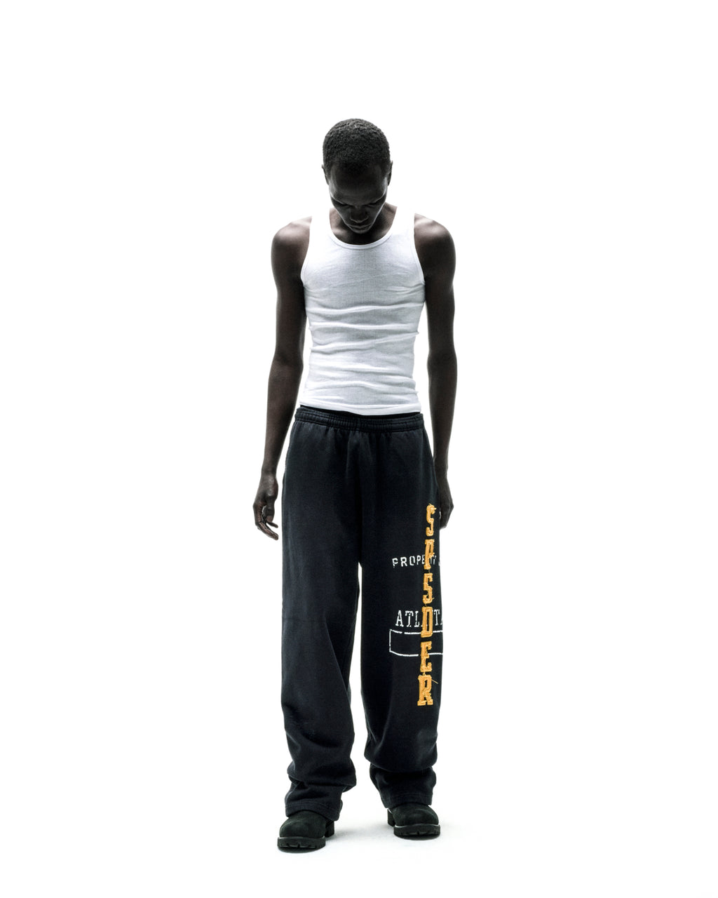 Black wide-leg ISSUE 404 SWEATPANT with yellow chenille "SPSDER" lettering and frayed edges.