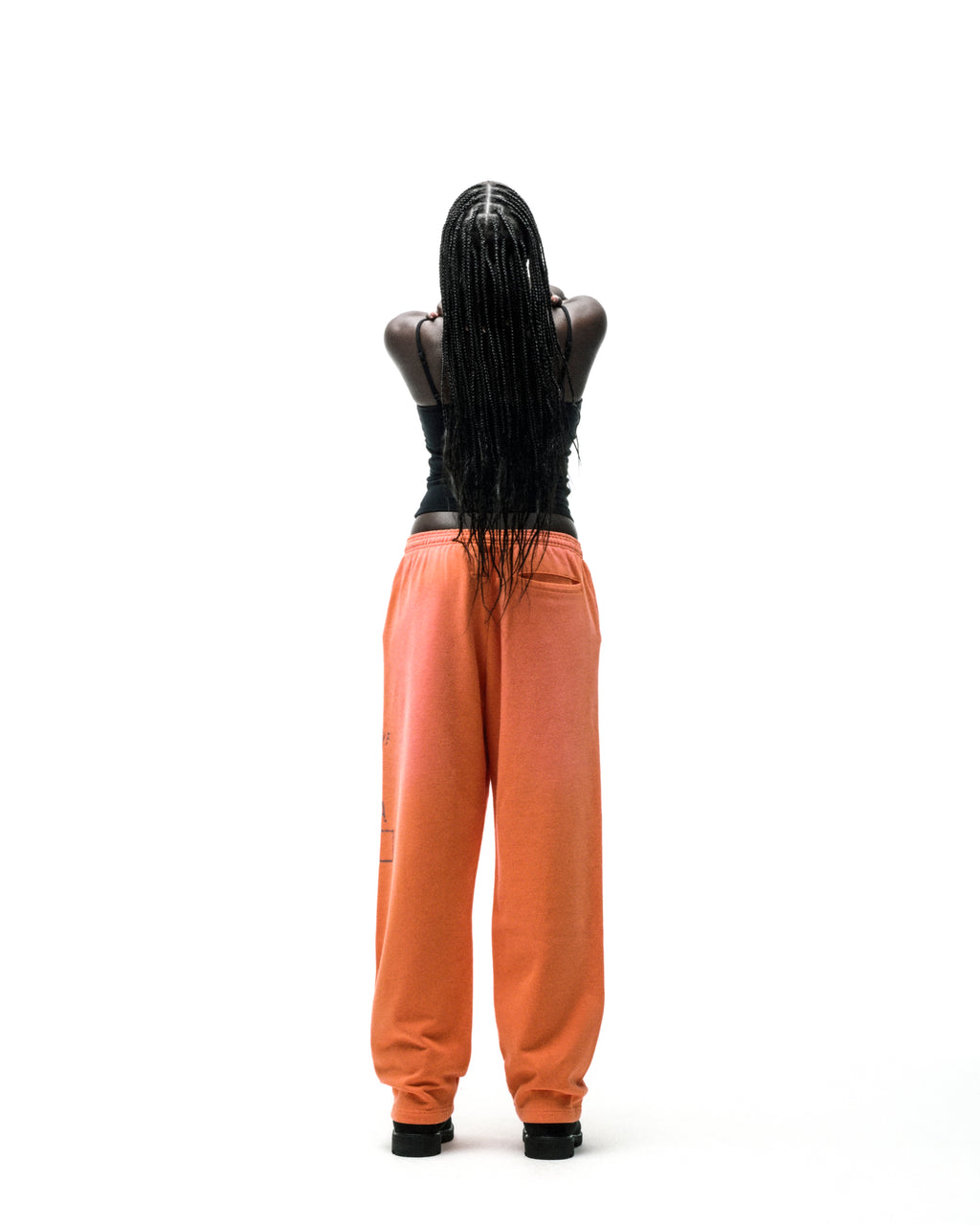 Orange ISSUE 404 wide-leg sweatpants with faded graphic print and raised chenille lettering.