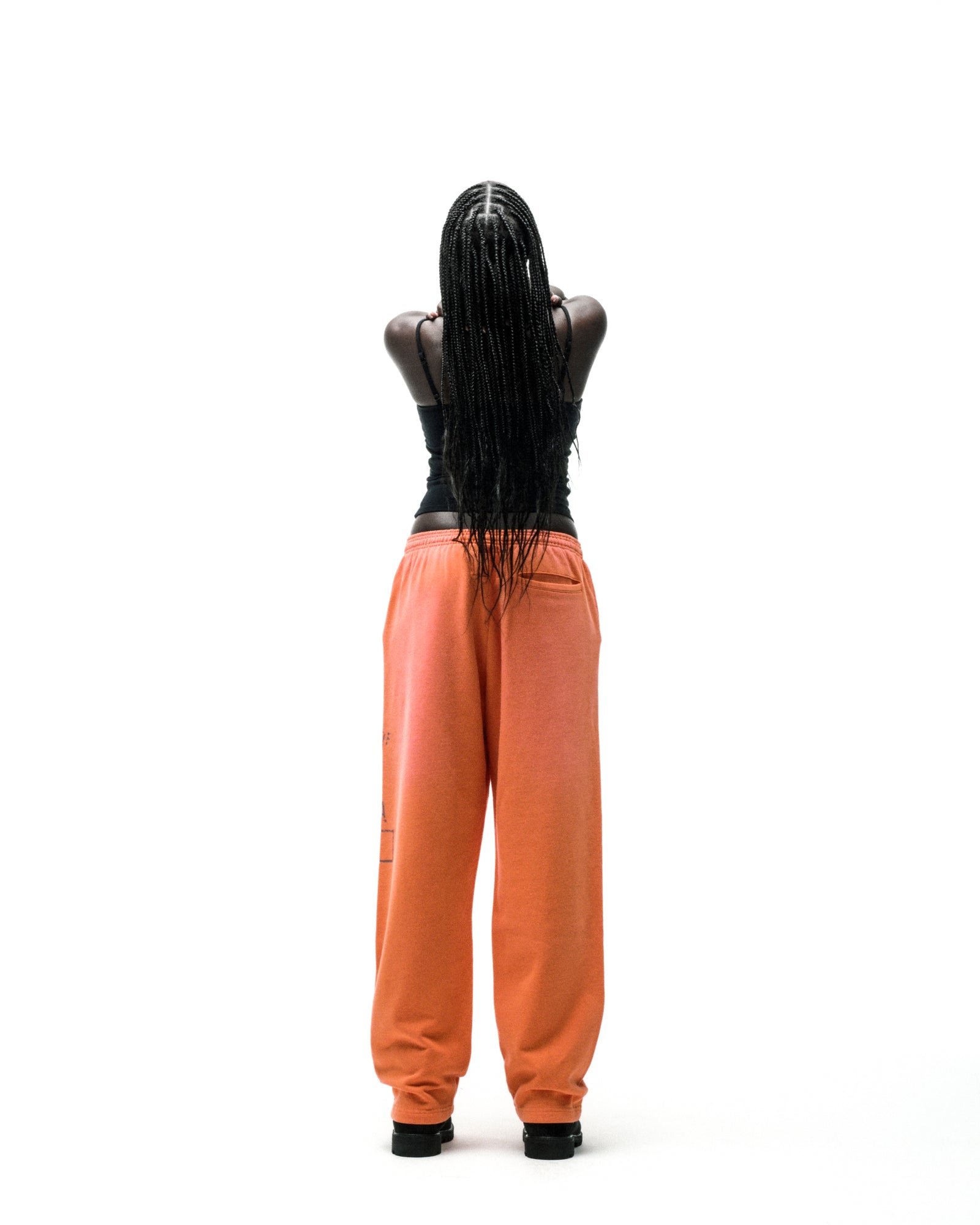 Orange ISSUE 404 wide-leg sweatpants with faded graphic print and raised chenille lettering.