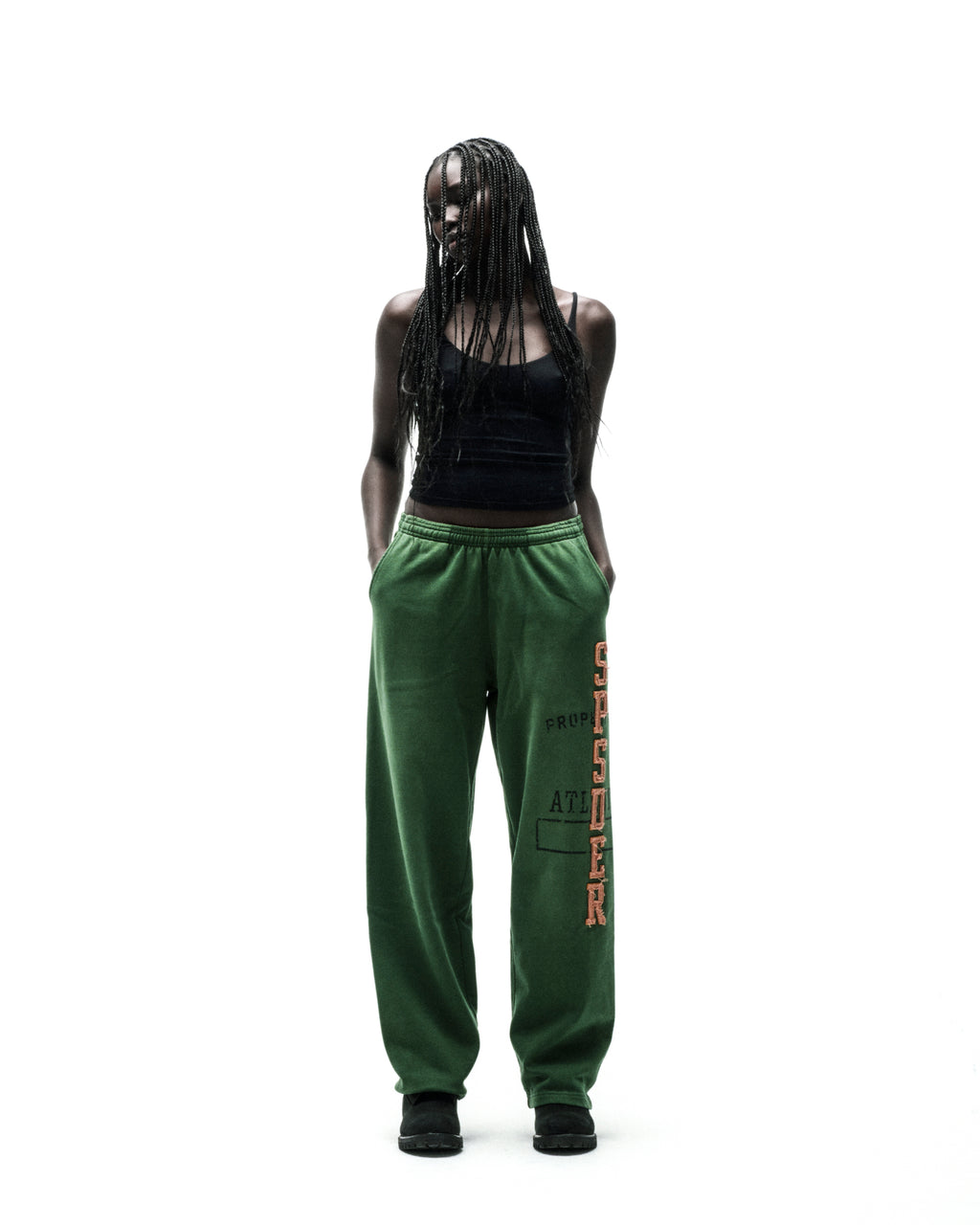 Green ISSUE 404 wide-leg sweatpants with raised chenille "SPSDER" lettering and frayed edges.