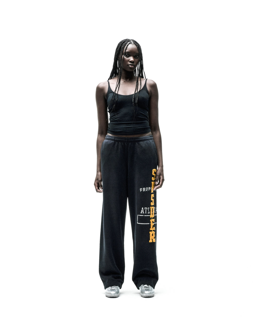 Black ISSUE 404 wide-leg sweatpants with raised chenille-style "SPSDER" lettering and frayed edges.