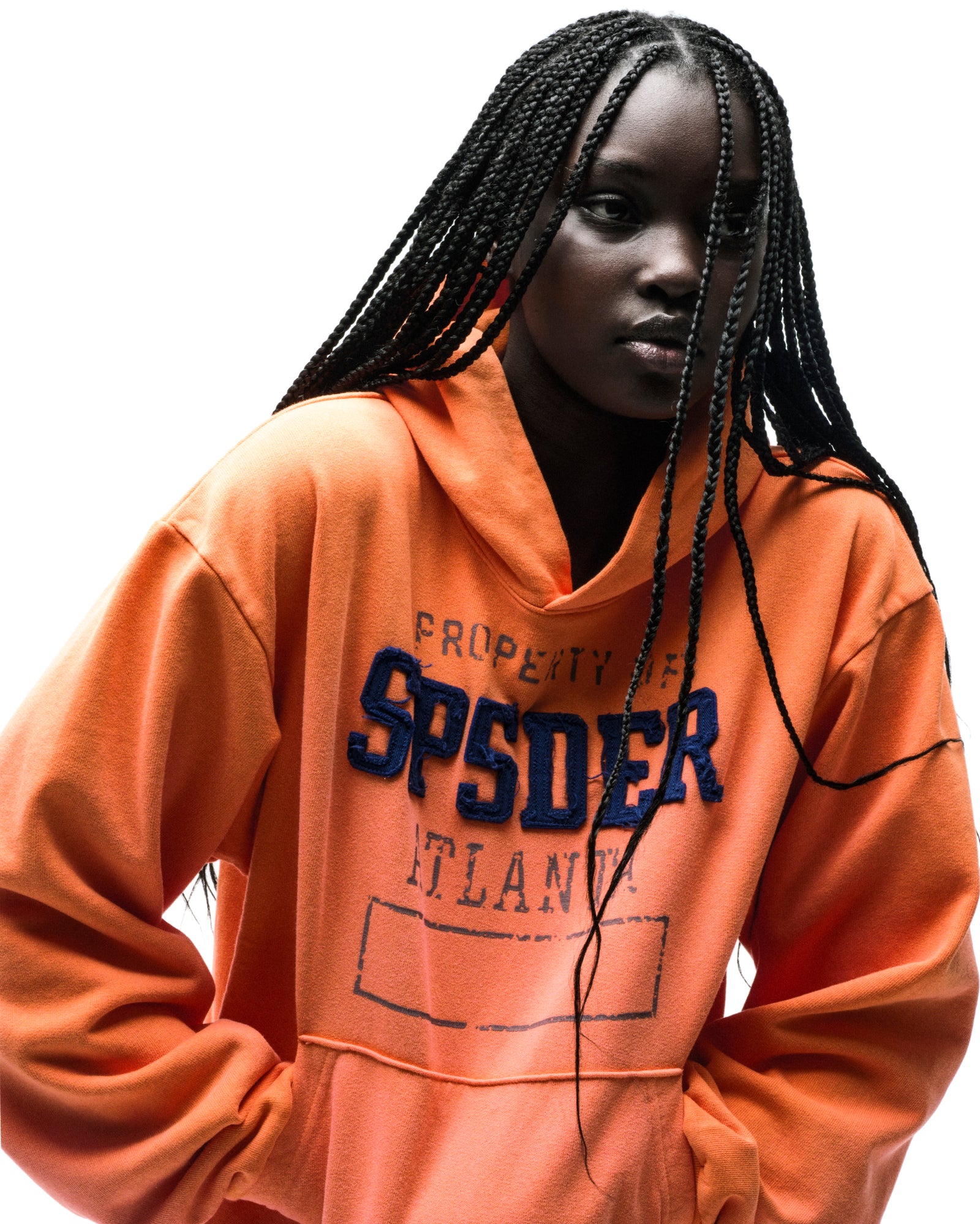 Orange cotton fleece hoodie with raised chenille "SPSDER" lettering and faded graphic print.