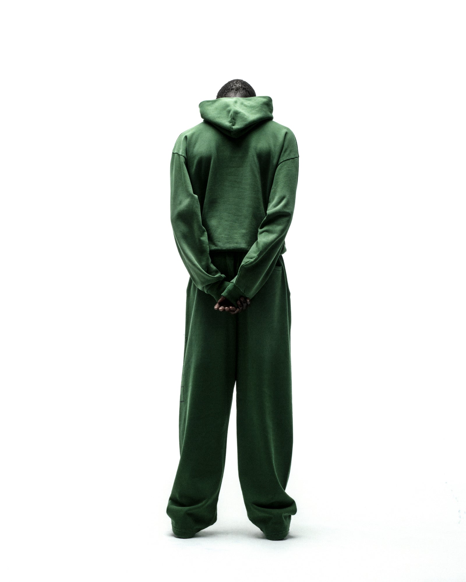 Dark green cotton fleece hoodie and sweatpants set, seen from behind.