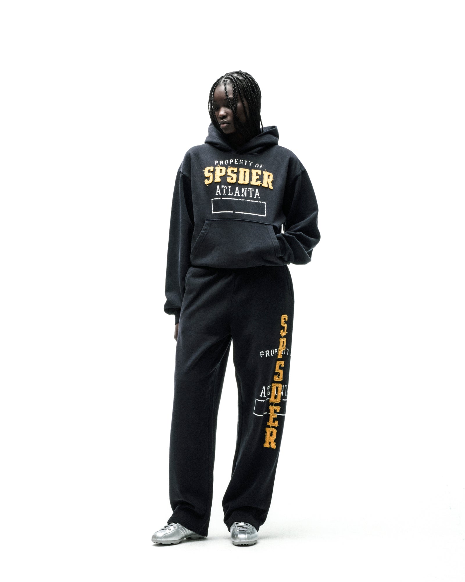 Black cotton fleece hoodie and sweatpants with raised "SP5DER ATLANTA" chenille lettering.