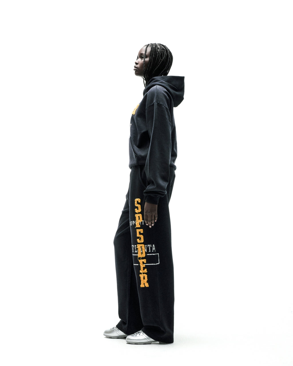 Black cotton fleece hoodie with faded yellow "SPSDER" lettering and frayed edges.