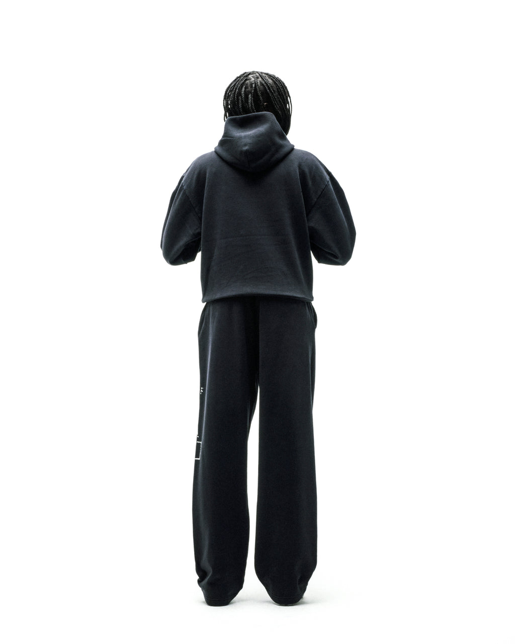 Black cotton fleece hoodie and sweatpants set, worn by a person from behind.