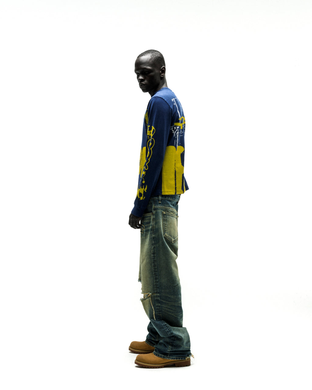 Model wearing a blue 100% cotton X-RAY LONGSLEEVE with yellow graphic print on front, back, and sleeves.