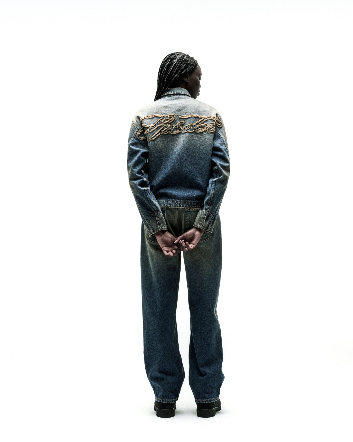 Washed blue denim work jacket with "SCRIPT" embroidery on back, paired with matching jeans.