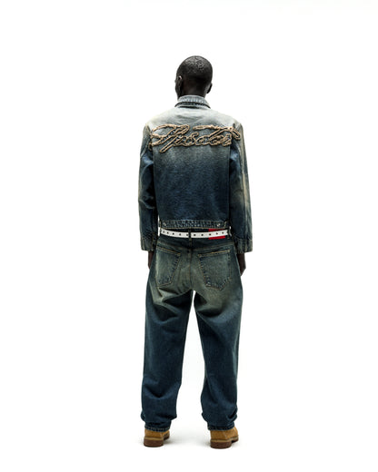 Distressed blue denim work jacket with "SCRIPT" embroidery on back, paired with matching jeans.
