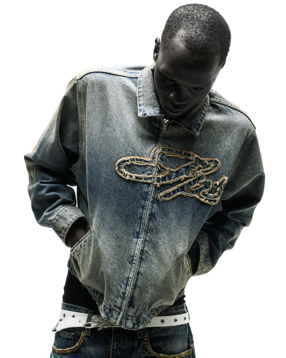 Washed blue denim work jacket with a unique script logo design on the chest.