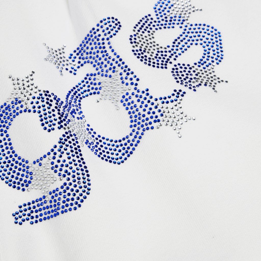 White cotton sweatshorts with flag-inspired rhinestone OG logo graphic.