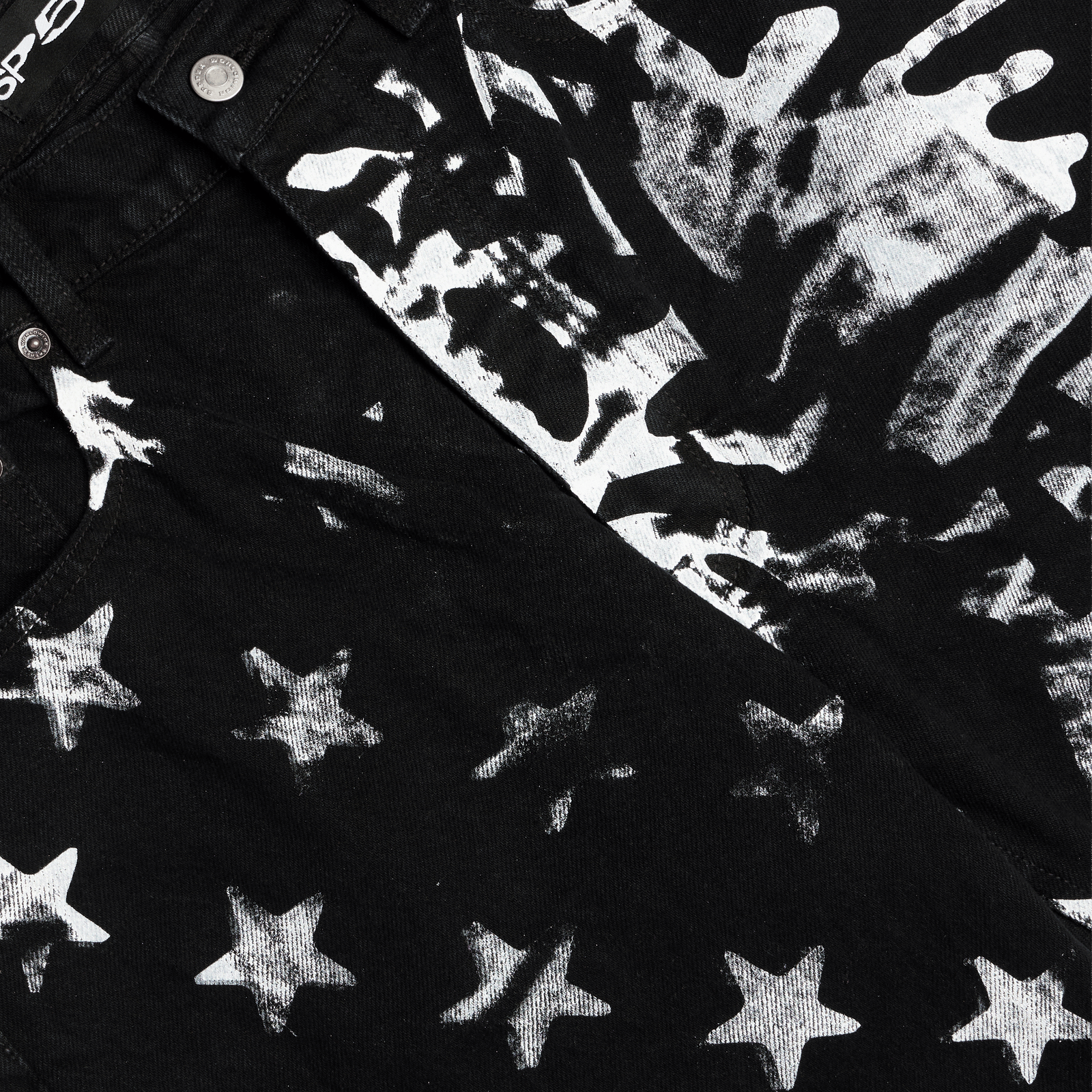 Black denim pants with white stars and web graphic print.