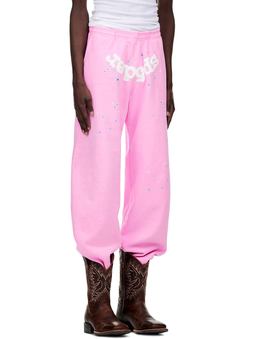 OG WEB PINK SWEATPANT: Pink fleece sweatpants with white puff print "sp5der" text and scattered stars.