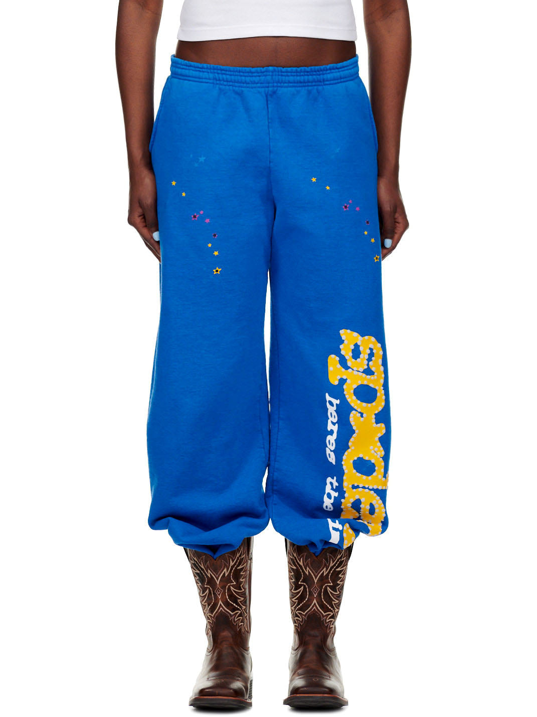 TC BLUE SWEATPANT, 23oz fleece, with yellow "SP5DER!" text and colorful star prints.