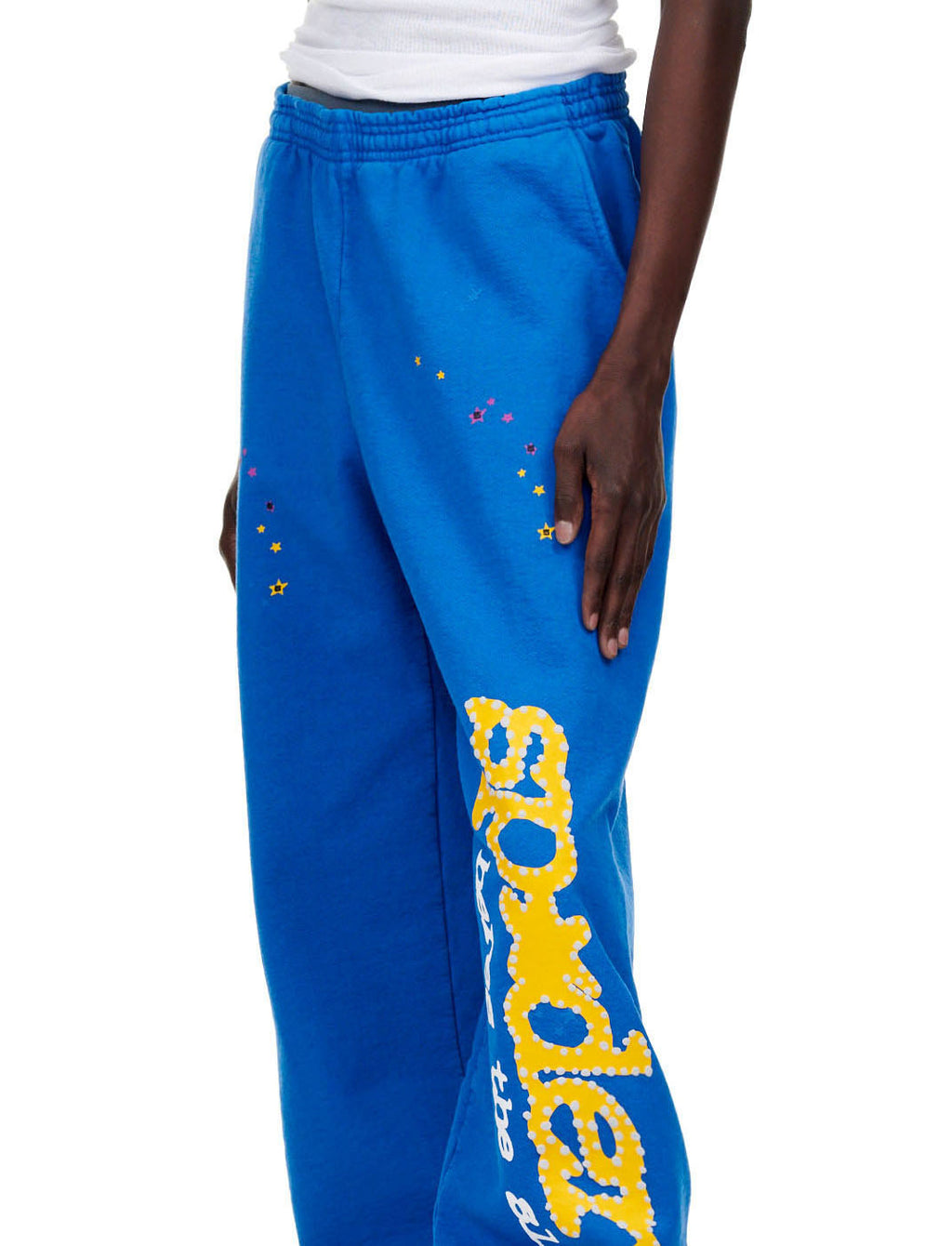 TC BLUE SWEATPANT with yellow "SP5DER!" text and star print down the leg.