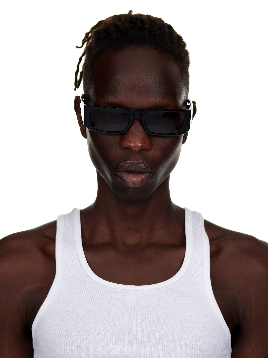 Model wearing SP5 x FLATLIST 'SLUG' sunglasses with black Mazzucchelli acetate frames and brown lenses.