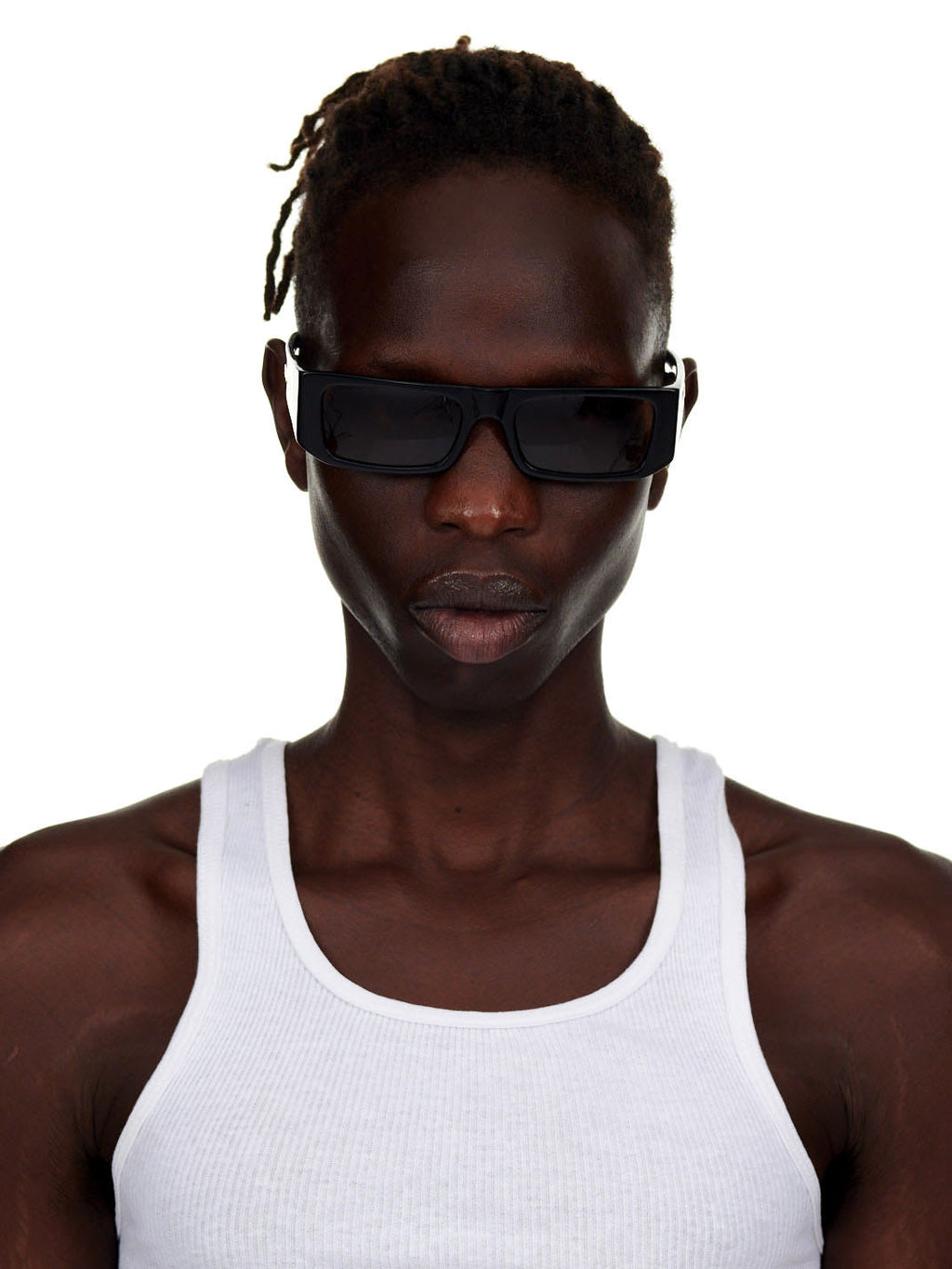 Model wearing SP5 x FLATLIST 'SLUG' sunglasses with black Mazzucchelli acetate frames and brown lenses.