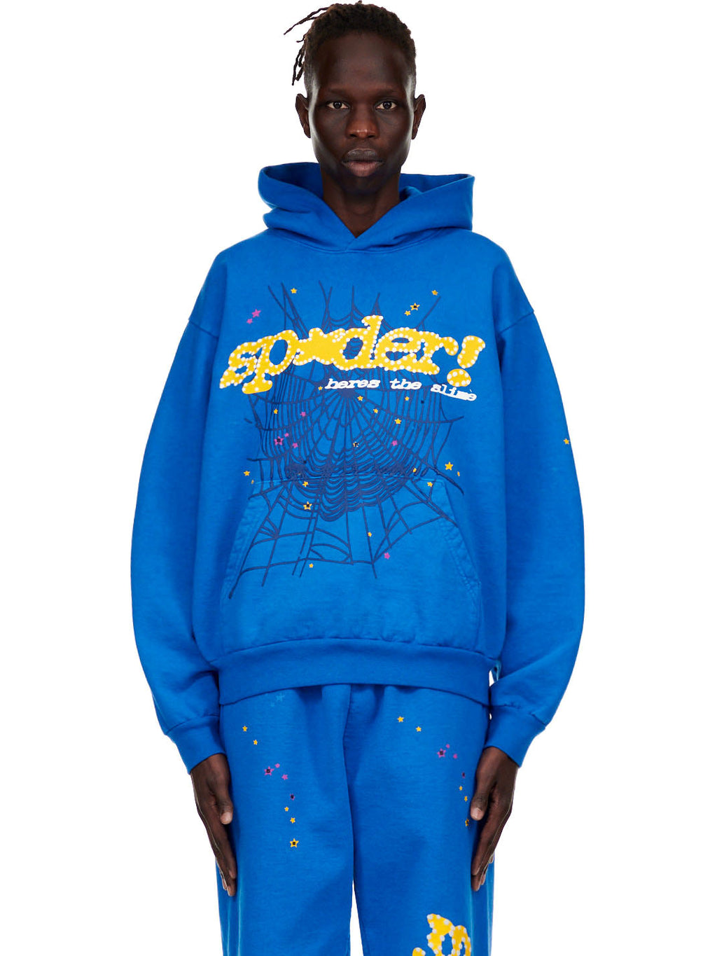 Male model in a blue fleece hoodie with yellow "SP5DER!" text, a spiderweb, and star prints.
