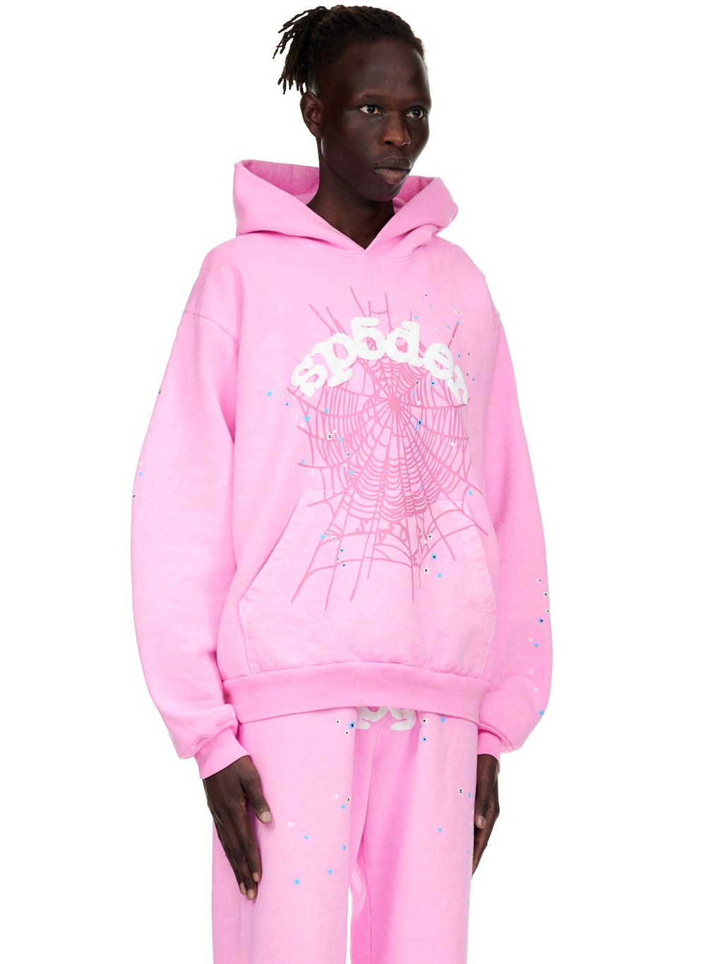 Male model in an OG WEB PINK HOODIE with white puff print "Sp5der" text and spider web design.