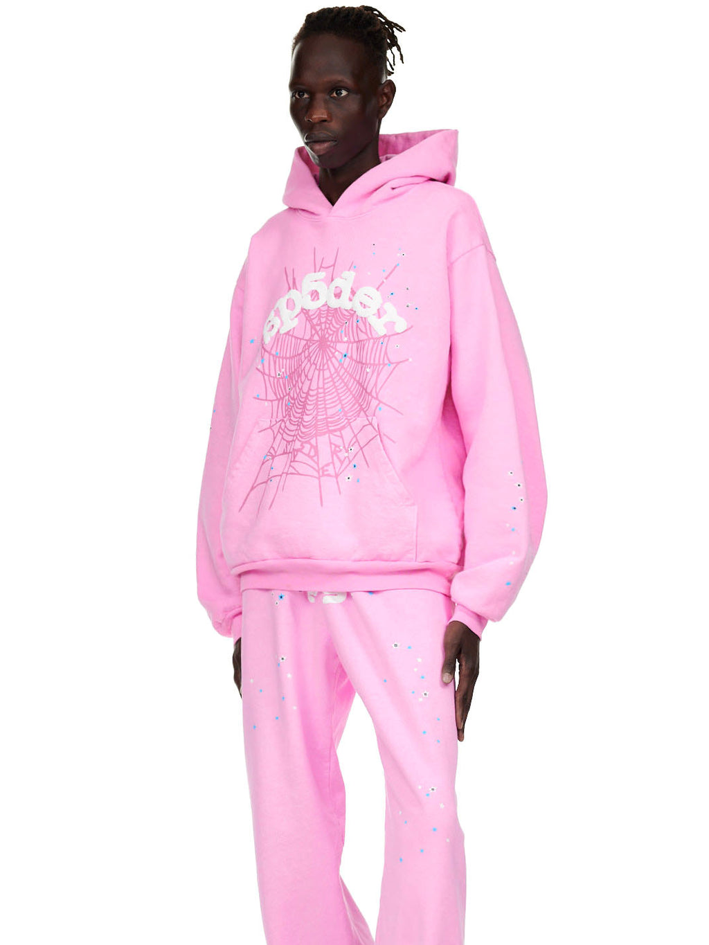 Male model wearing an OG WEB PINK HOODIE and matching sweatpants with puff print spider web design.