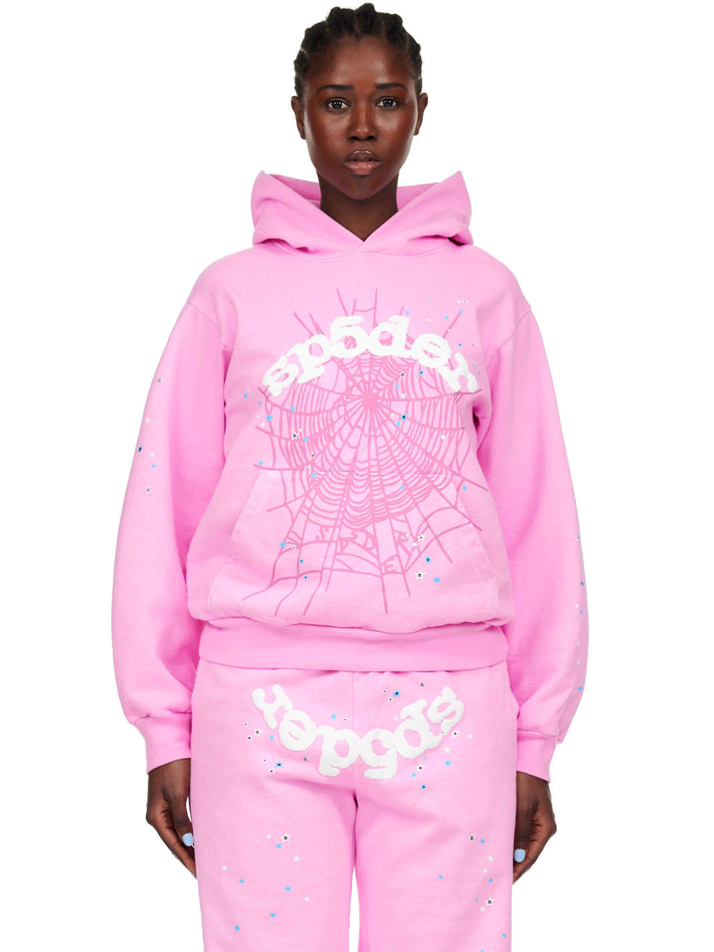 Female model in OG WEB PINK HOODIE, 23oz fleece, with white puff print SP5DER text and web design.
