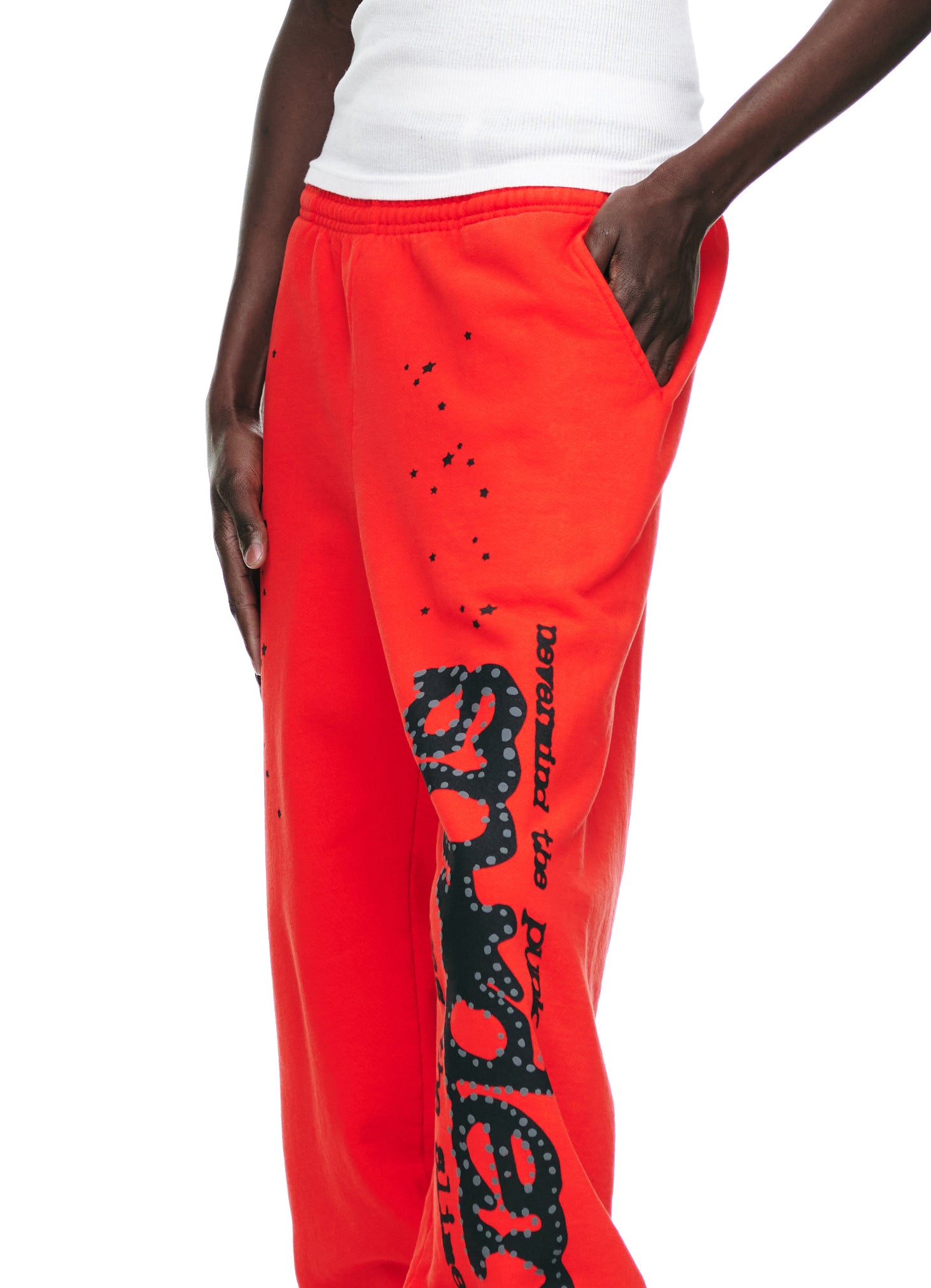 Red P*NK V2 sweatpants with black SP5DER motif, star prints, and "never mind the p*nk" text.