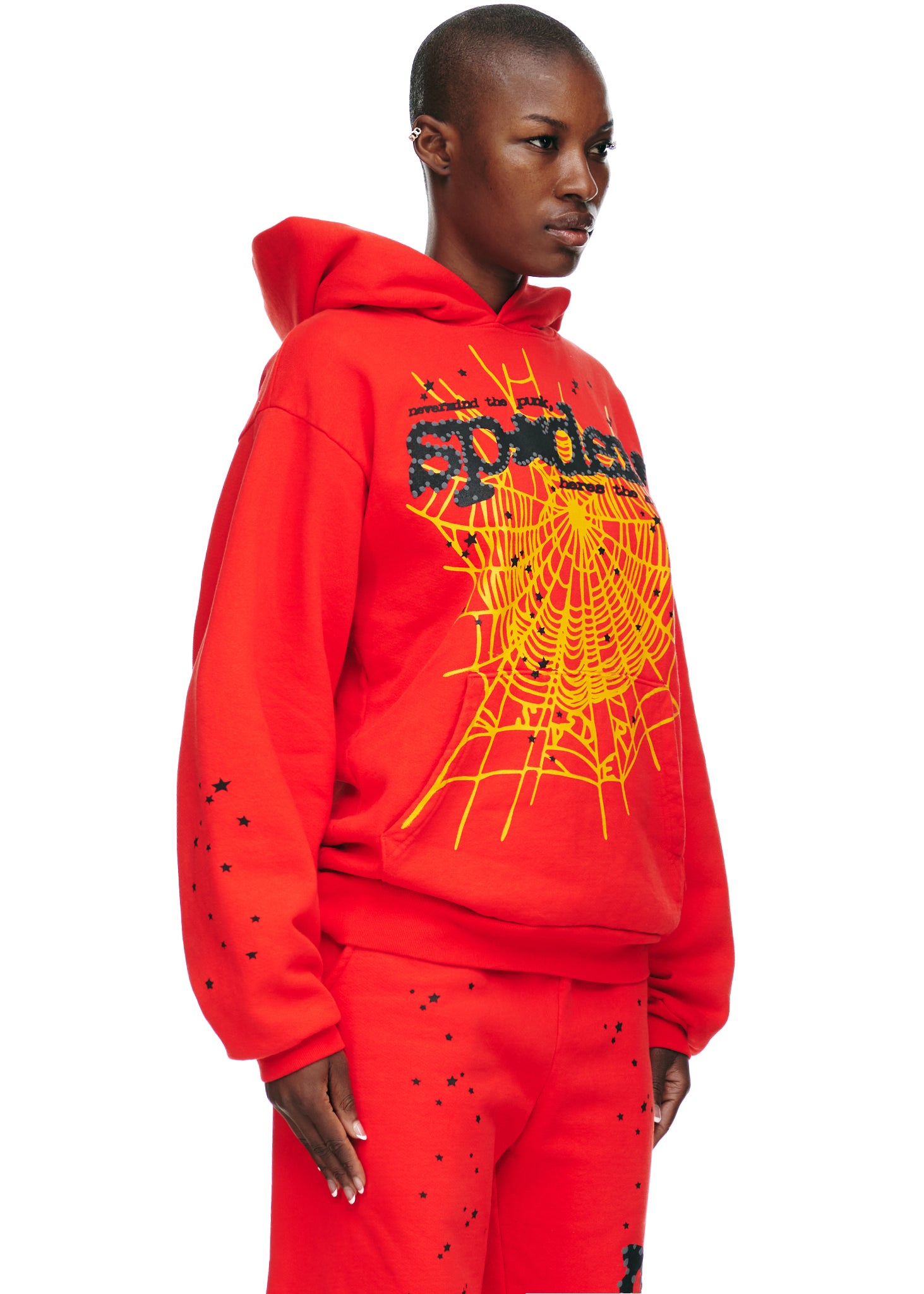 Red P*NK V2 hoodie with yellow SP5DER web, star, and text prints.