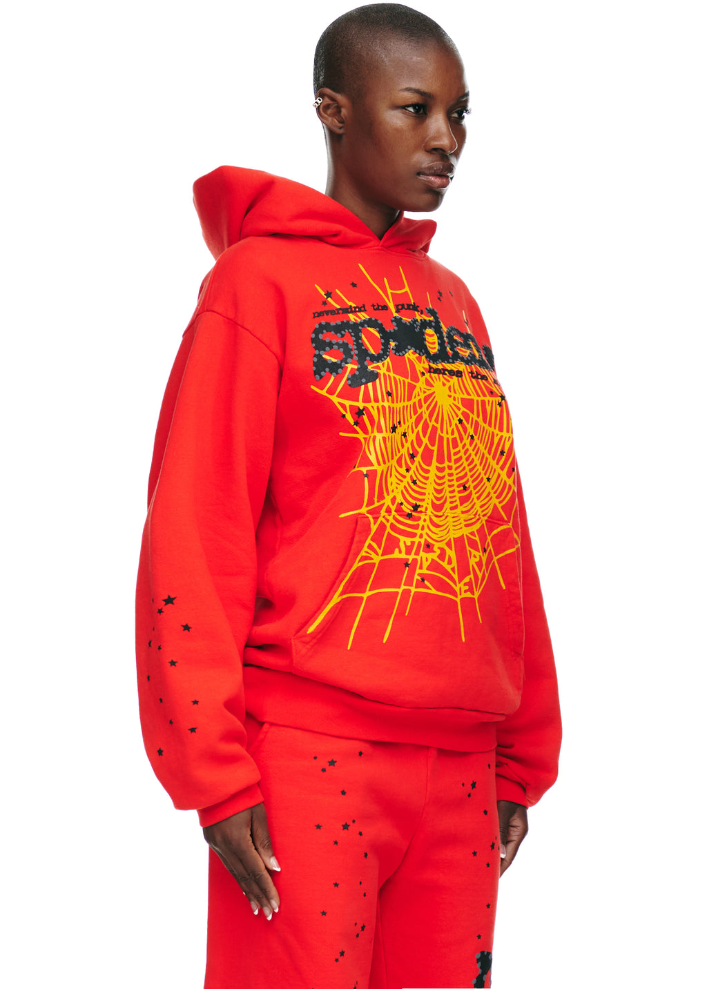Red P*NK V2 hoodie with yellow SP5DER web, star, and text prints.