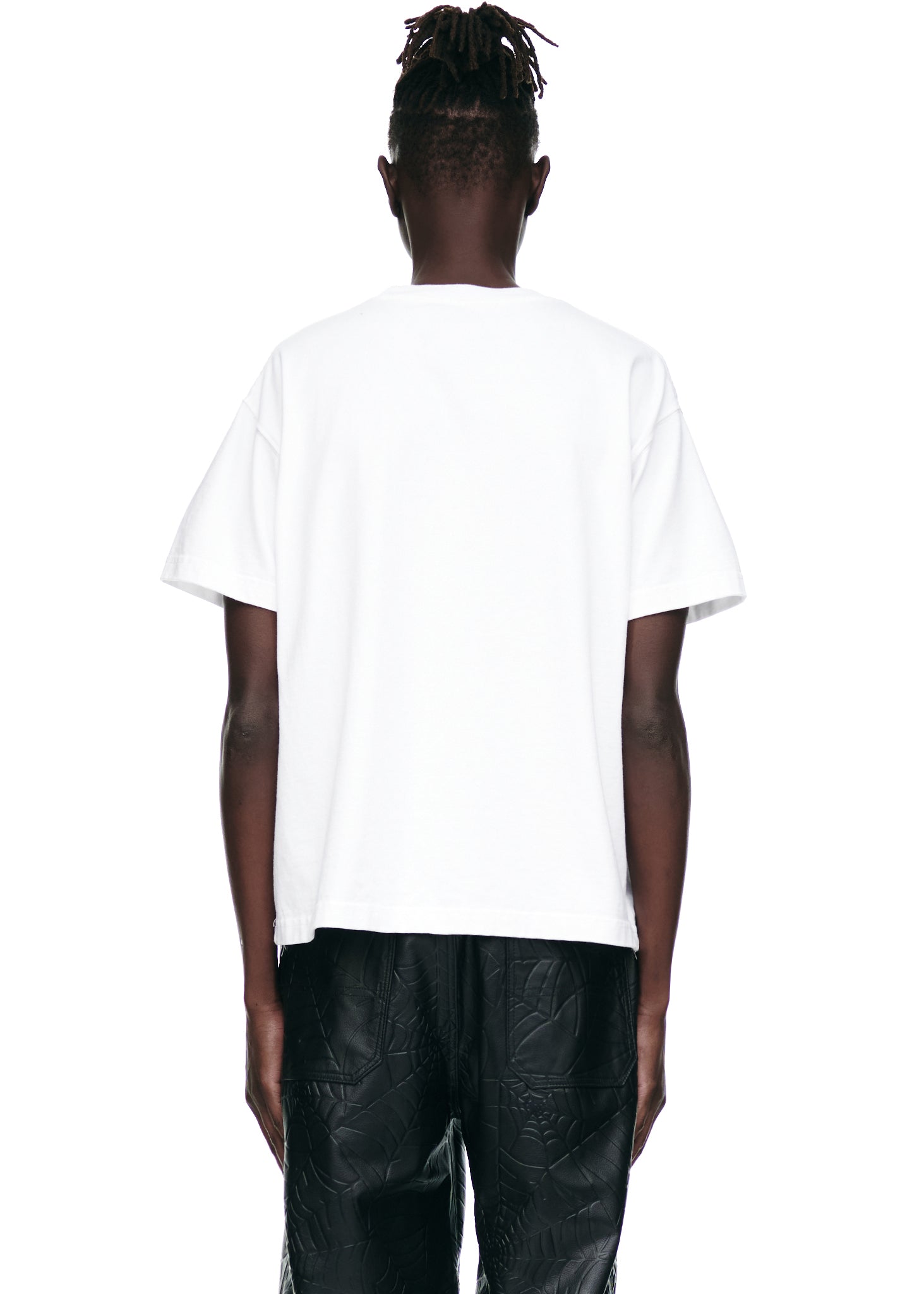 Back view of male model wearing a white 100% cotton SOUVENIR TEE with a standard fit.