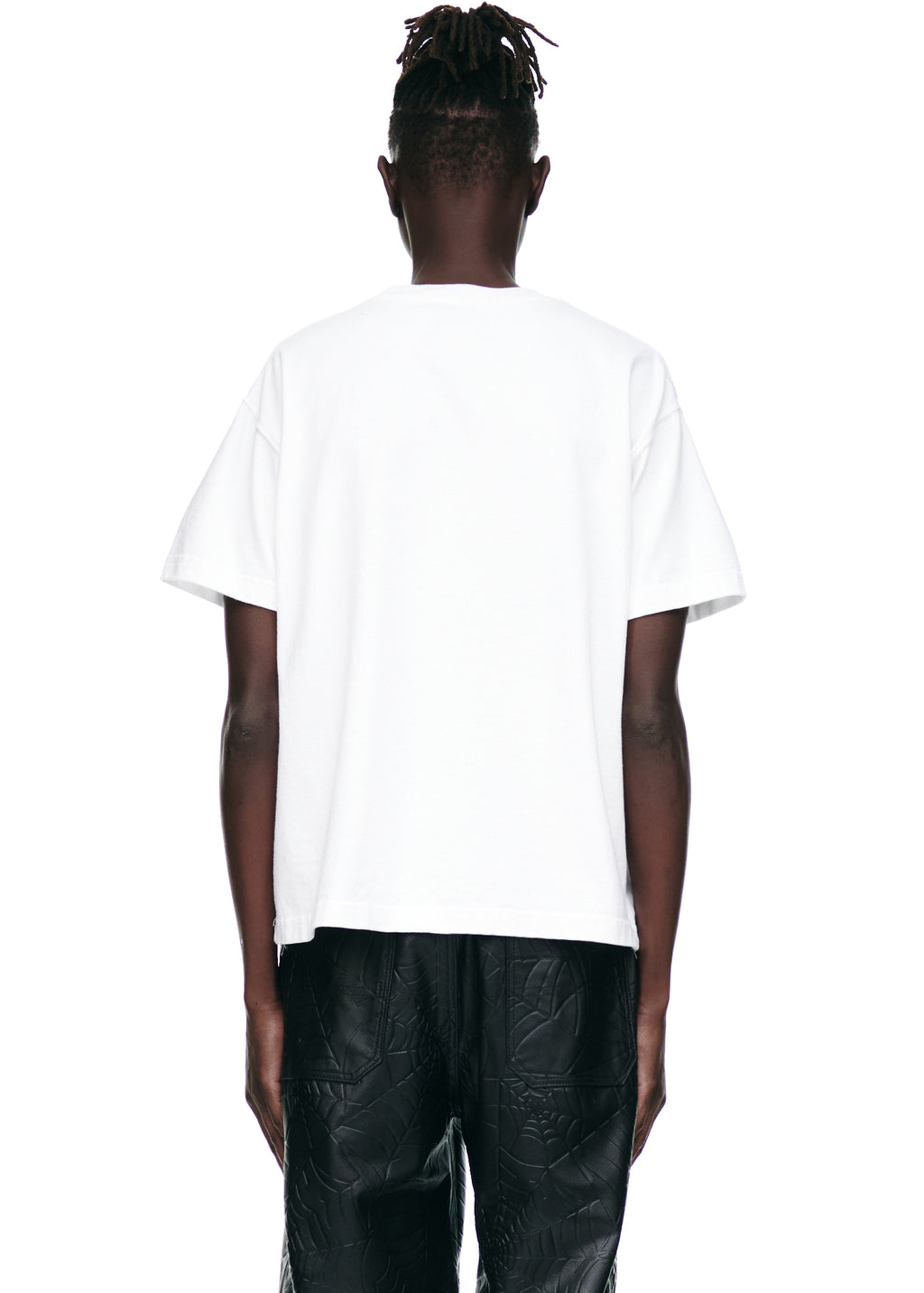 Back view of male model wearing a white 100% cotton SOUVENIR TEE with a standard fit.