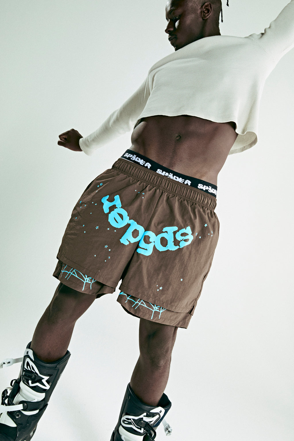 Brown OG WEB double layer shorts with blue "hepgods" text, stars, and SP5DER waistband.