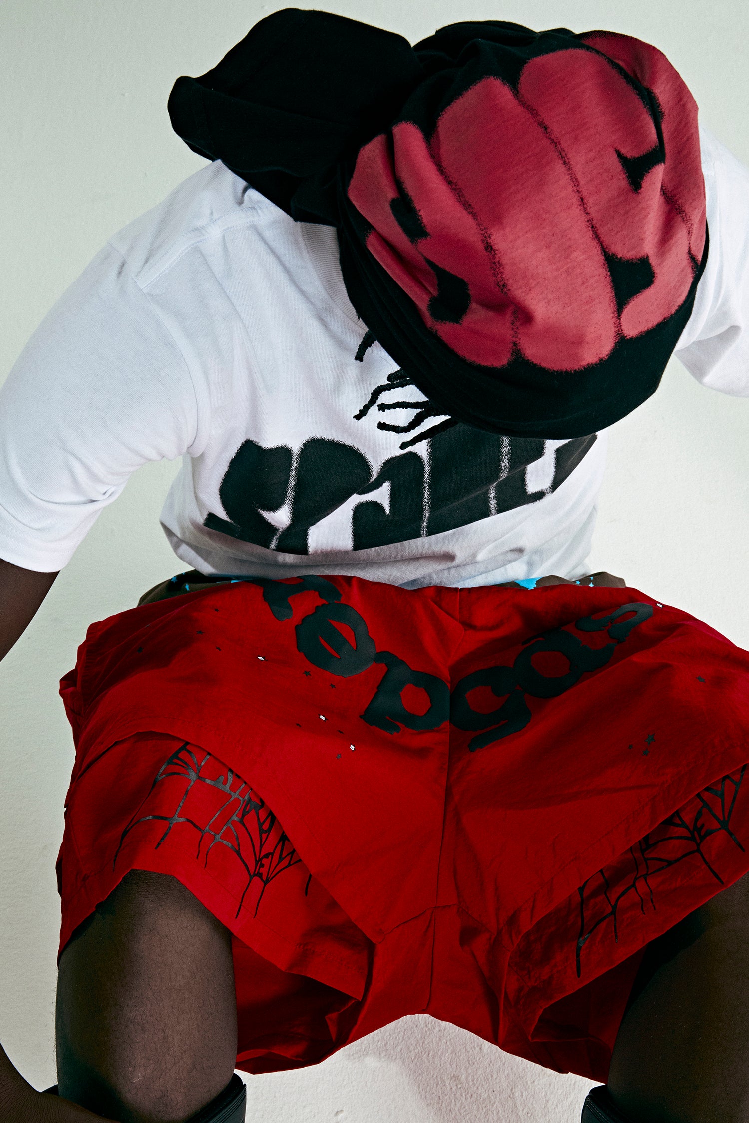 Red OG WEB Double Layer Short with black text and star print, made from water-repellent nylon.