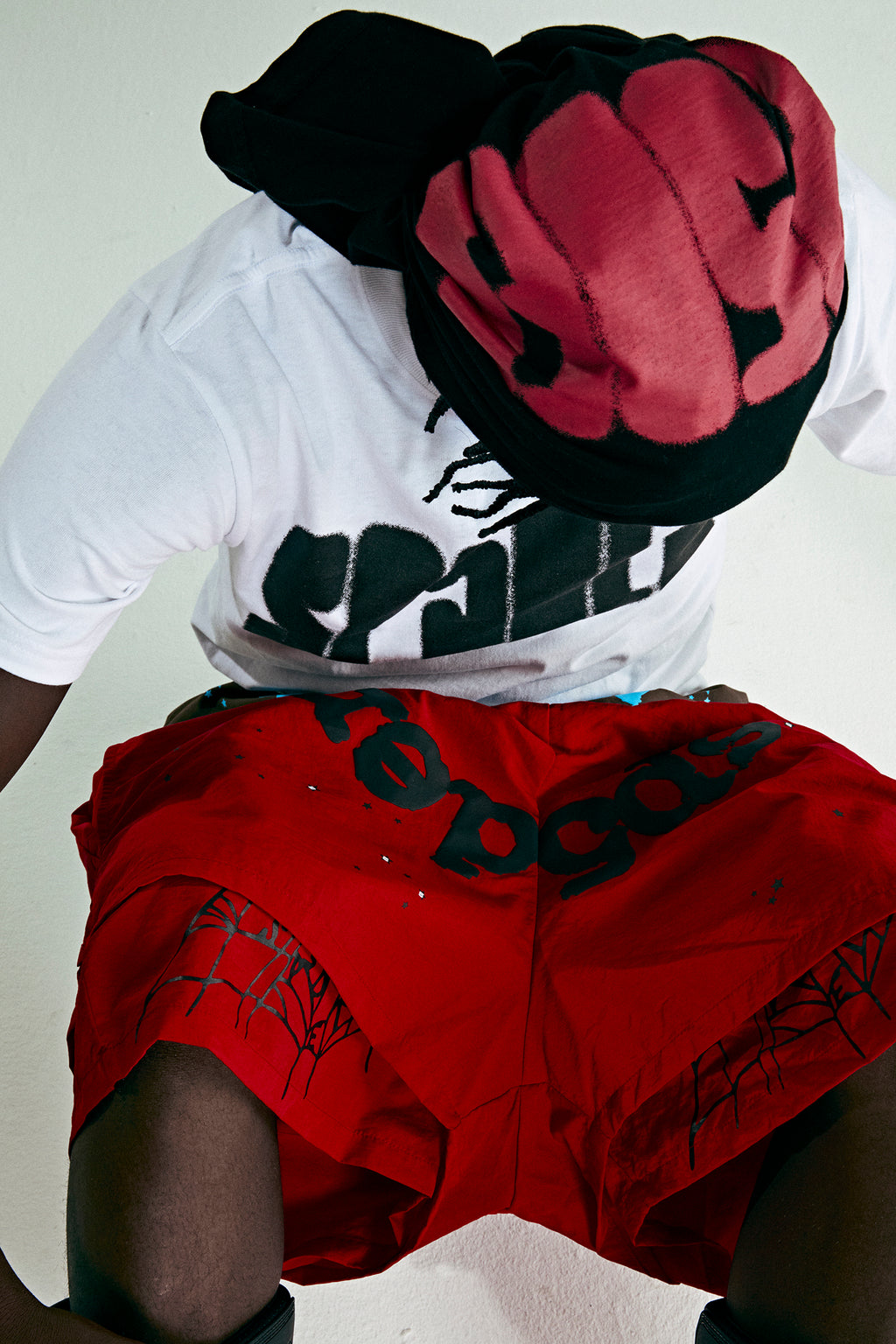 Red OG WEB Double Layer Short with black text and star print, made from water-repellent nylon.