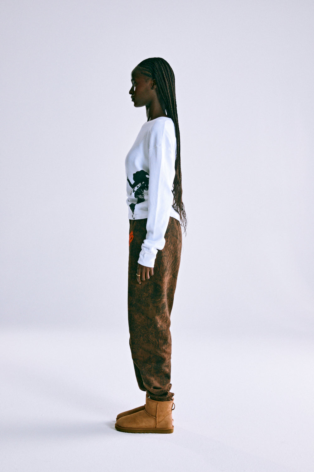 Brown T&F Tree Camo Sweatpants with SP5DER text, worn by a model.