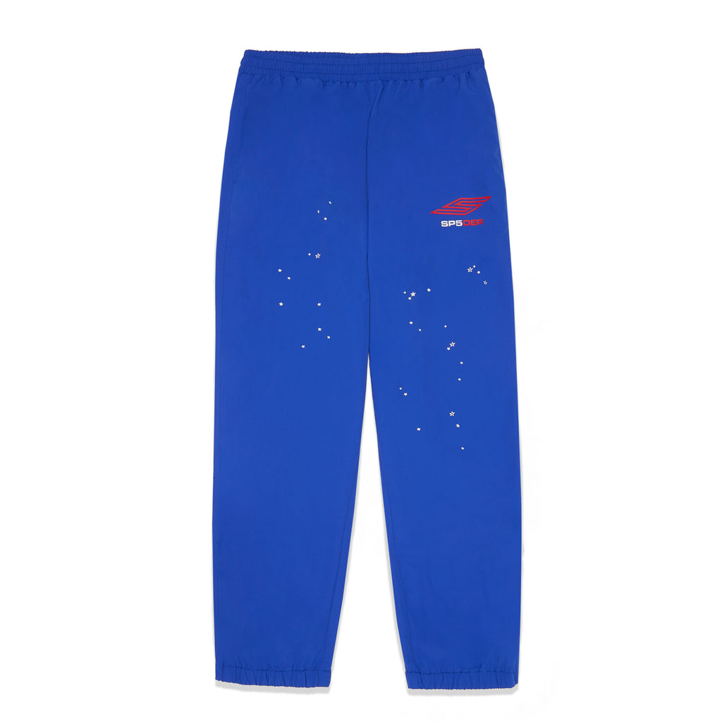 SP5DER PRO Wind Pant: Blue nylon ripstop with red logo, scattered white stars, and elastic cuffs.