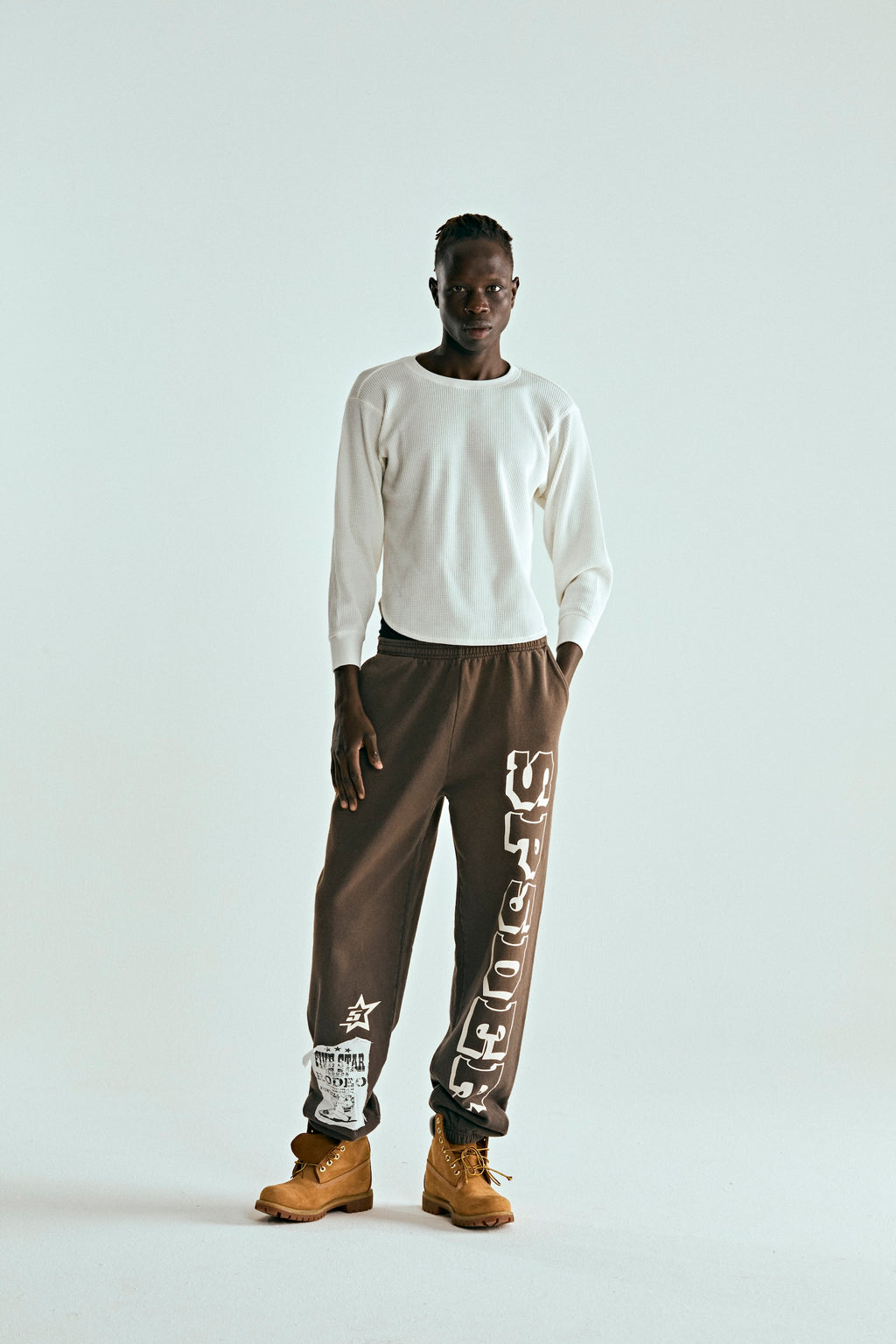 Brown 5STAR RODEO SWEATPANT with white SP5DER text, distressed patch, and side stripe.
