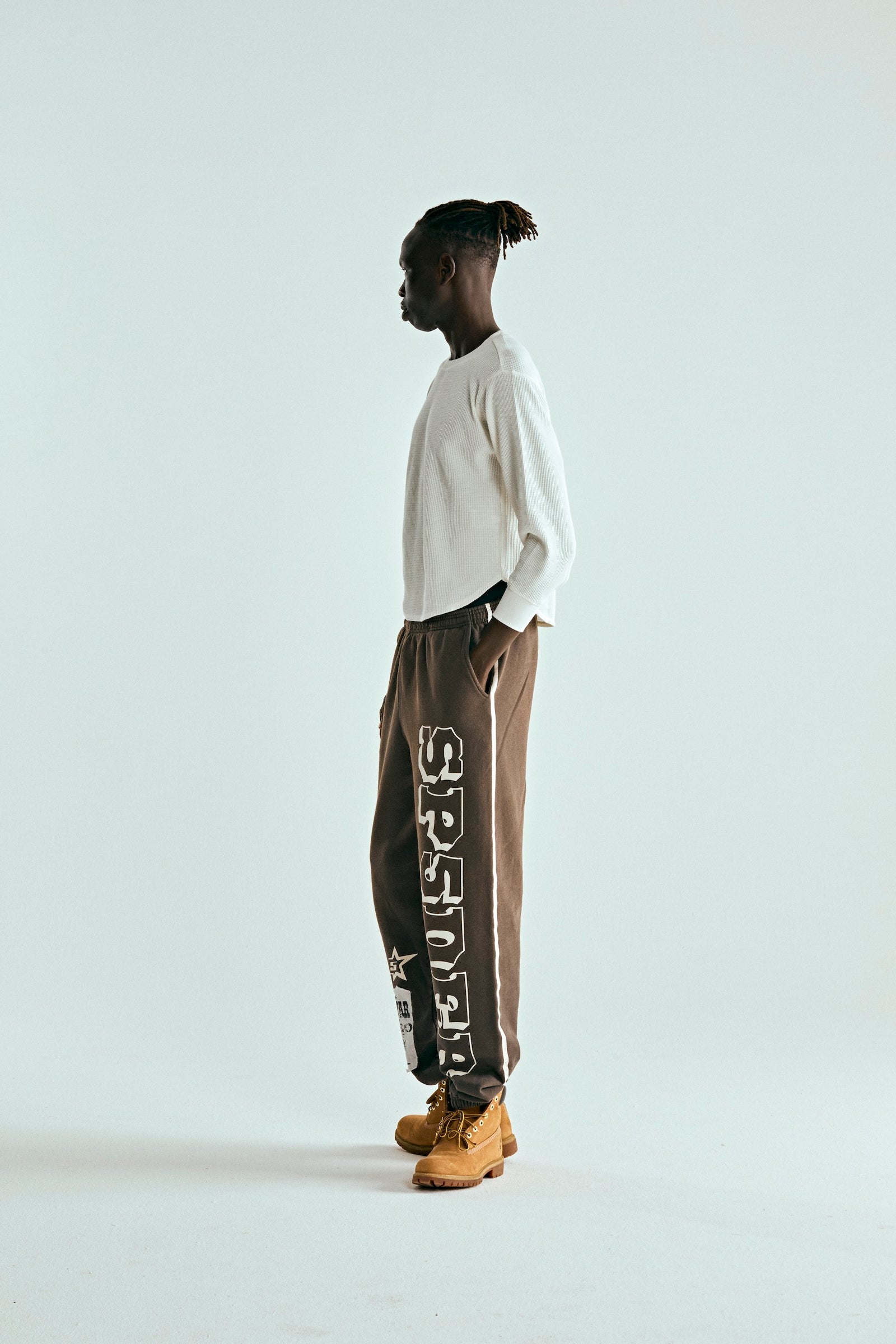 Brown 5STAR RODEO SWEATPANT with SP5DER text, side stripe, and distressed patch.